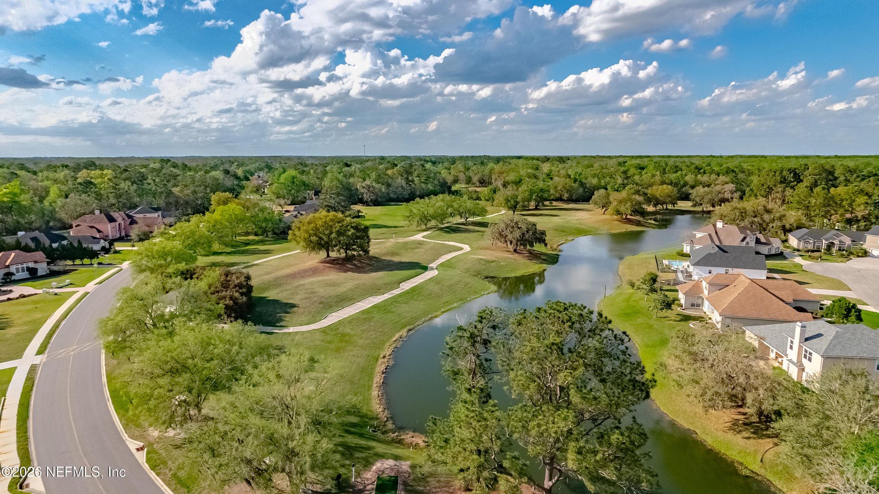 An aerial view over the lagoon and fairways at Orange Park